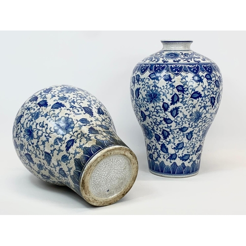 415 - A pair of large vintage Chinese blue and white pottery vases. 26 x 36cm