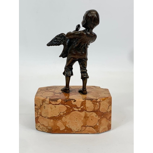 427 - A bronze figure on slate base. 10 x 6 x 17cm