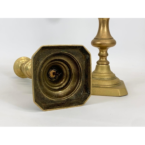 435 - A pair of Victorian brass candlesticks. 28cm