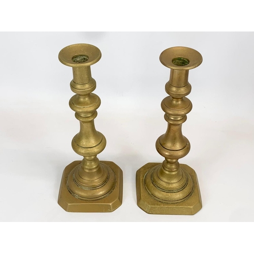 435 - A pair of Victorian brass candlesticks. 28cm