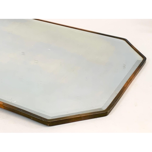 44 - An Edwardian copper framed mirror. 39 x 67.5cm