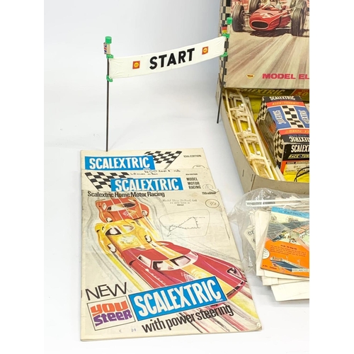 53 - A vintage Scalextric racing set in original box. Including 6 cars, 6 remotes, 3 instruction books an... 