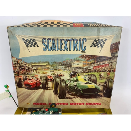 53 - A vintage Scalextric racing set in original box. Including 6 cars, 6 remotes, 3 instruction books an... 