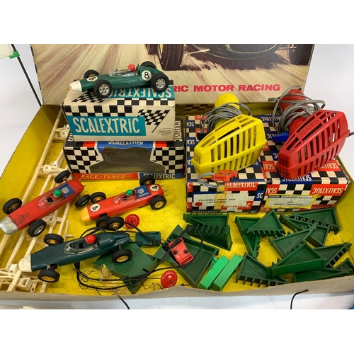 53 - A vintage Scalextric racing set in original box. Including 6 cars, 6 remotes, 3 instruction books an... 