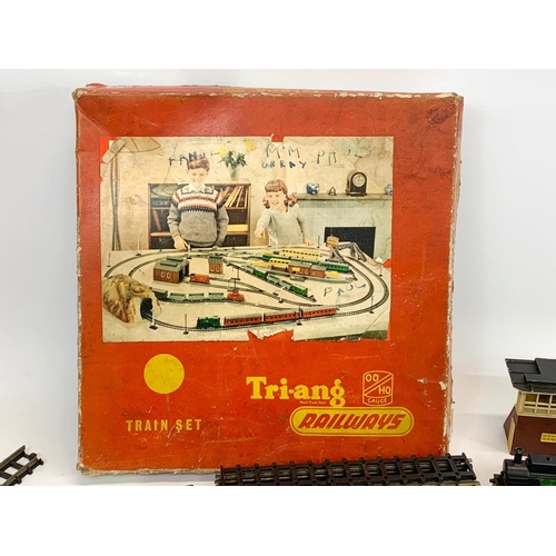 56 - A vintage Triang (Tri-ang) Railways Train Set in original box. Including 2 trains, 3 carts, tracks e... 