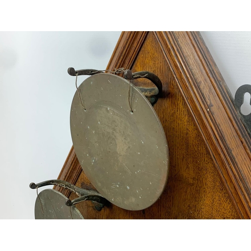 66 - A large late 19th century wall mounted bronze gong on oak frame. 58 x 89cm.