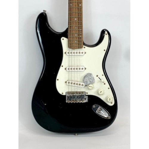 68 - An electric guitar by Fender. Squier Strat. 99cm