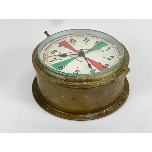 77 - A vintage Kelvin Hughes brass Bulkhead Ships Clock. Battery. 18.5 x 8cm