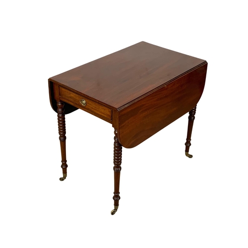 933 - A Victorian mahogany Pembroke drop leaf table with drawer and brass cup casters. Open 106 x 84 x 73.... 