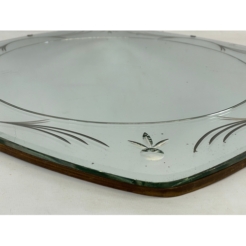 355 - An Art Deco bevelled mirror. 50cm