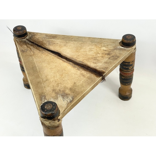 358 - An early 20th century Middle Eastern Hide top stool. 43 x 28.5cm