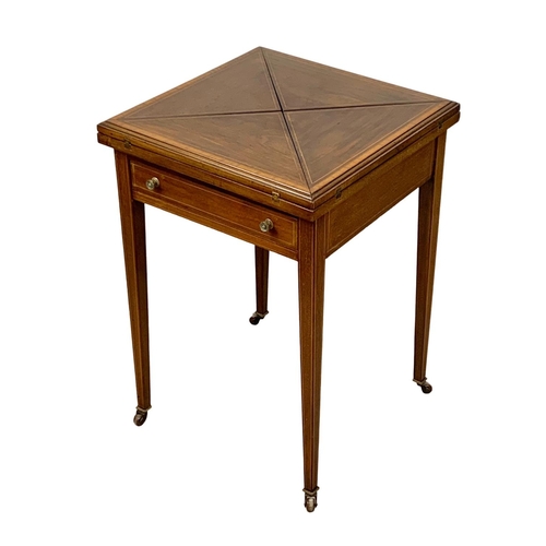 1092 - An Edwardian inlaid mahogany envelope games table. 51 x 51 x 74.5cm