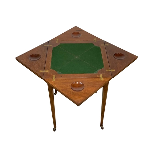 1092 - An Edwardian inlaid mahogany envelope games table. 51 x 51 x 74.5cm