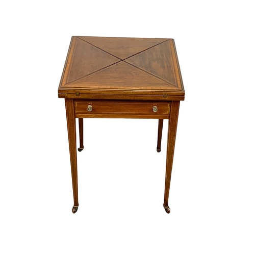 1092 - An Edwardian inlaid mahogany envelope games table. 51 x 51 x 74.5cm