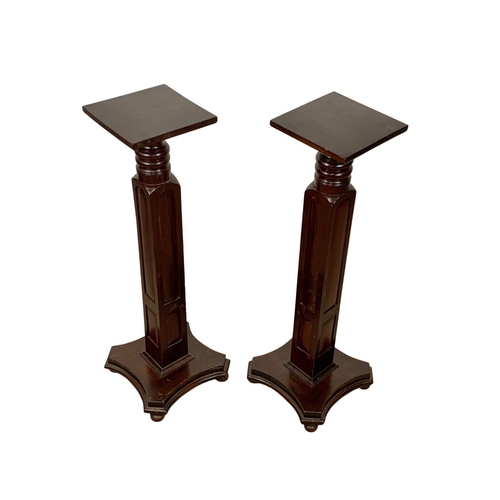 1097 - A pair of tall mahogany jardiniere stands. 34 x 97cm