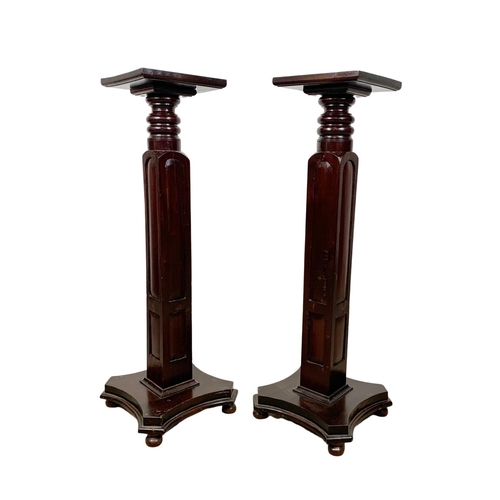 1097 - A pair of tall mahogany jardiniere stands. 34 x 97cm