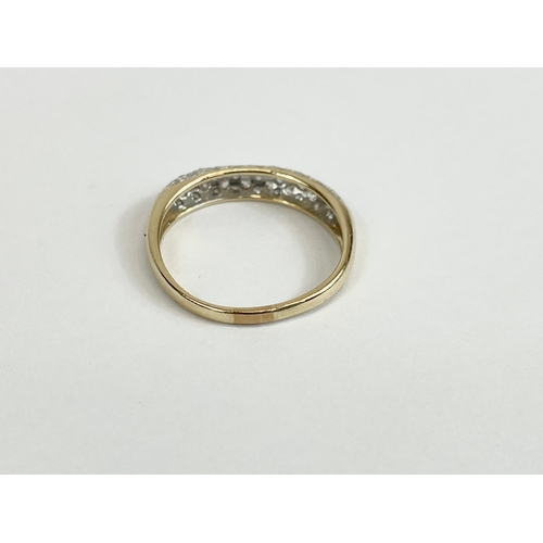 526 - A ladies 9ct gold and diamond ring. Size M. 1.8 grams.