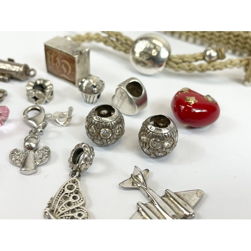 534 - A quantity of silver charms and a silver Links London bracelet.