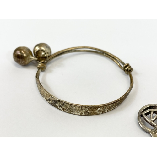 596 - 2 silver brooches and a bangle.