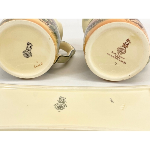 419 - 3 pieces of Royal Doulton “Rustic England” pottery. Plate measures 28cm. Jugs measure 15 x 12cm