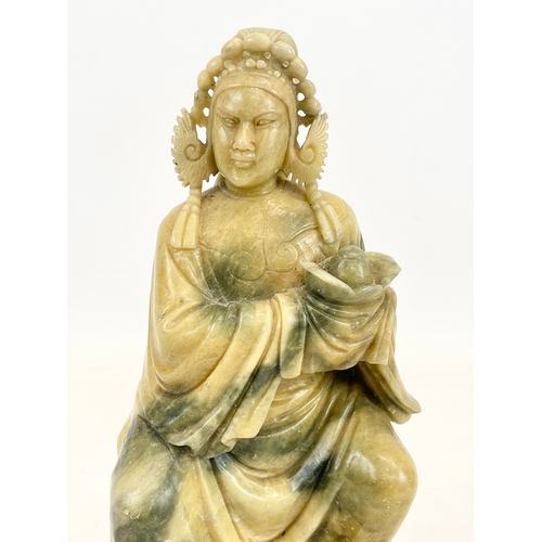 433 - An early 20th century Chinese soapstone figure on a carved wooden base. Circa 1900. 17 x 25cm