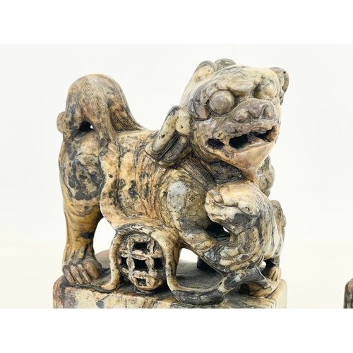 434 - A pair of early 20th century Chinese soapstone Foo Dogs on stands. With engraved writing and flower ... 