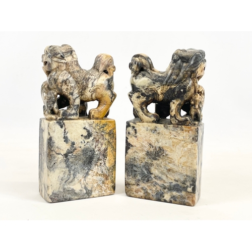 434 - A pair of early 20th century Chinese soapstone Foo Dogs on stands. With engraved writing and flower ... 