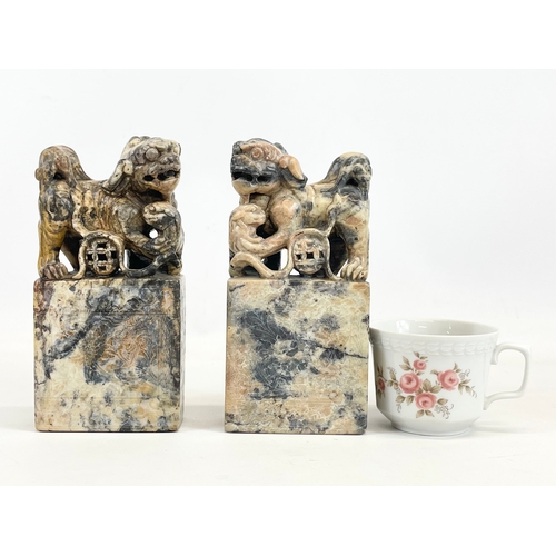 434 - A pair of early 20th century Chinese soapstone Foo Dogs on stands. With engraved writing and flower ... 