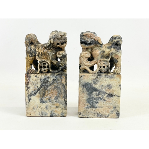 434 - A pair of early 20th century Chinese soapstone Foo Dogs on stands. With engraved writing and flower ... 