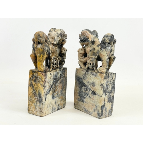 434 - A pair of early 20th century Chinese soapstone Foo Dogs on stands. With engraved writing and flower ... 