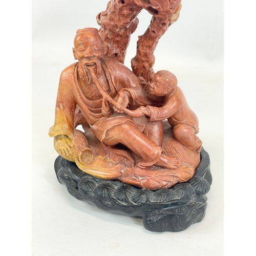 435 - An early 20th century Chinese soapstone figure on soapstone base. Circa 1900. 25cm