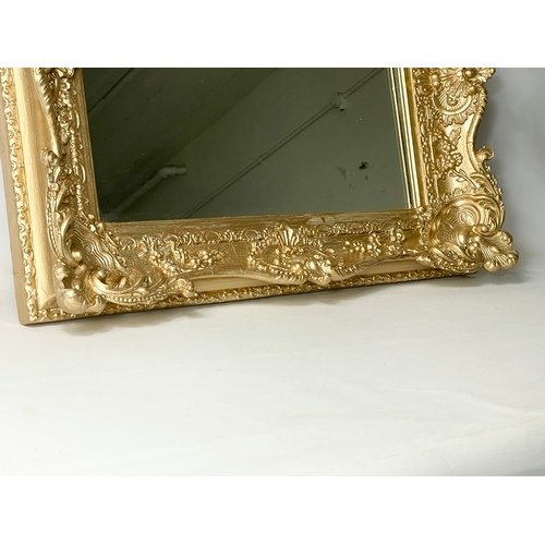 45 - A Victorian ornate gilt framed mirror. Repainted. 77 x 13 x 63cm