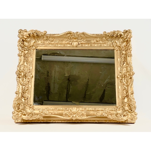 45 - A Victorian ornate gilt framed mirror. Repainted. 77 x 13 x 63cm