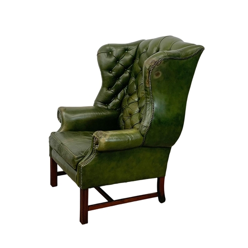 868 - A large Georgian style deep button leather wingback armchair. 82 x 94 x 112cm.