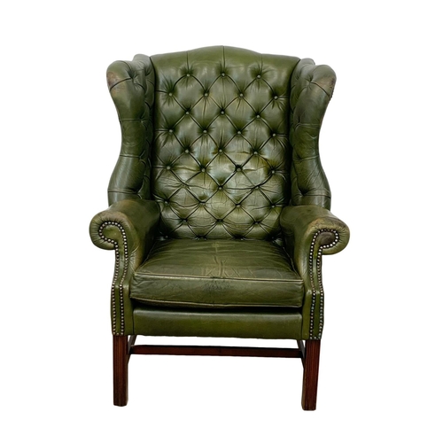 868 - A large Georgian style deep button leather wingback armchair. 82 x 94 x 112cm.