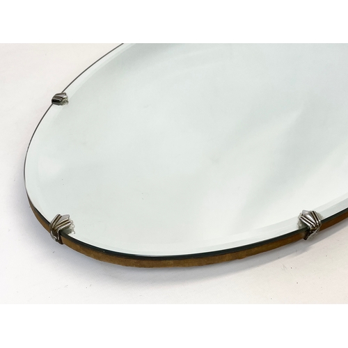 78 - A 1930’s Art Deco bevelled mirror. 66 x 38cm