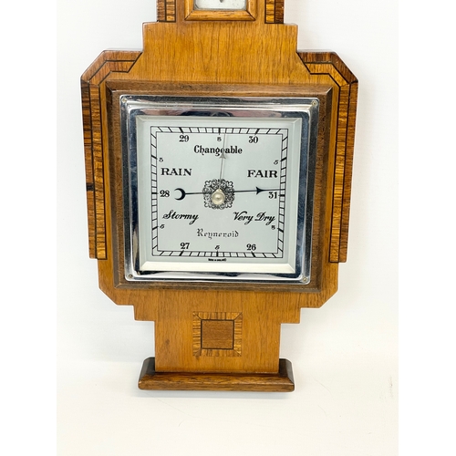 48 - An Edwardian inlaid barometer. 20 x 56cm