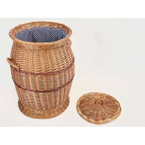 84 - A large Wicker 2 handled linen hamper with lid. 48 x 61cm