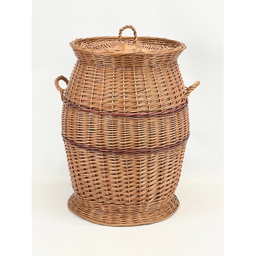 84 - A large Wicker 2 handled linen hamper with lid. 48 x 61cm