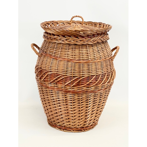 85 - A large wicker 2 handled linen hamper with lid. 48 x 61cm