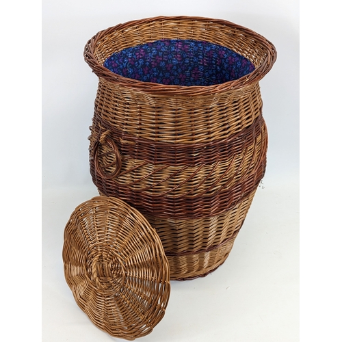 87 - A large wicker 2 handled basket with lid. 41.5x60cm