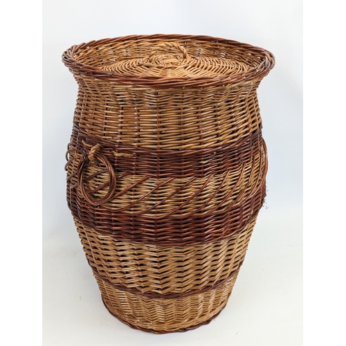 87 - A large wicker 2 handled basket with lid. 41.5x60cm