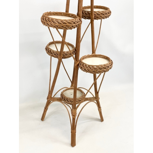 92 - A tall wicker plantstand. 113cm