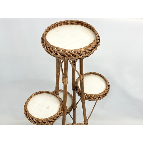 92 - A tall wicker plantstand. 113cm