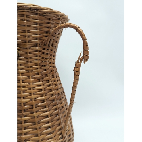 96 - 4 pieces of wicker, including 3 vases and a stick stand. Stick stand measures 42.5cm