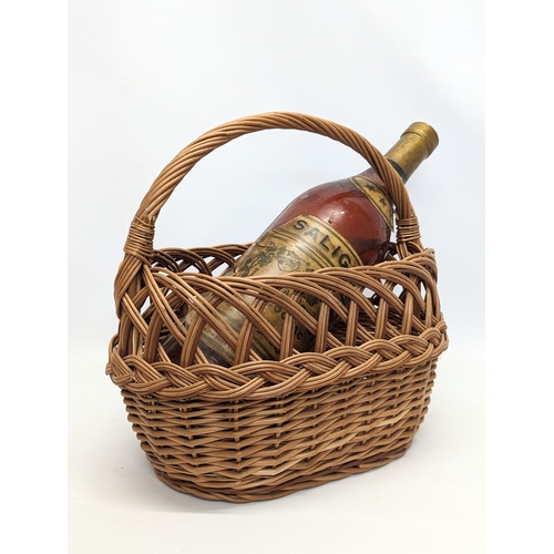 100 - A wicker ornamental basket with large Salingnac bottle. 38x37cm