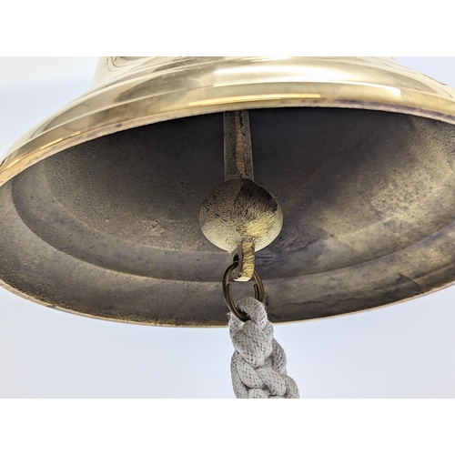 104 - A hanging brass bell. 20cm