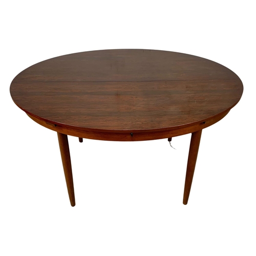 925 - A Greaves & Thomas rosewood extending Mid Century dining table. 1960’s. Open 142.5 x 138 x 74.5cm.