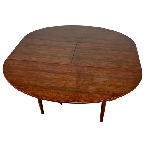 925 - A Greaves & Thomas rosewood extending Mid Century dining table. 1960’s. Open 142.5 x 138 x 74.5cm.