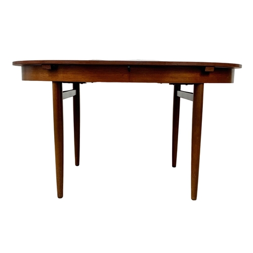 925 - A Greaves & Thomas rosewood extending Mid Century dining table. 1960’s. Open 142.5 x 138 x 74.5cm.